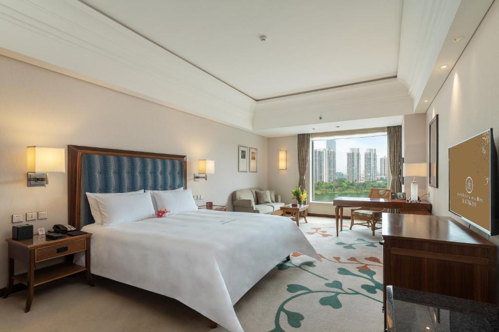 Postel nebo postele na pokoji v ubytování Huizhou Kande International Hotel