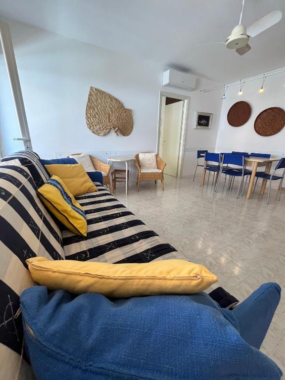 a living room with a couch and tables and chairs at Santis 1 in Grado
