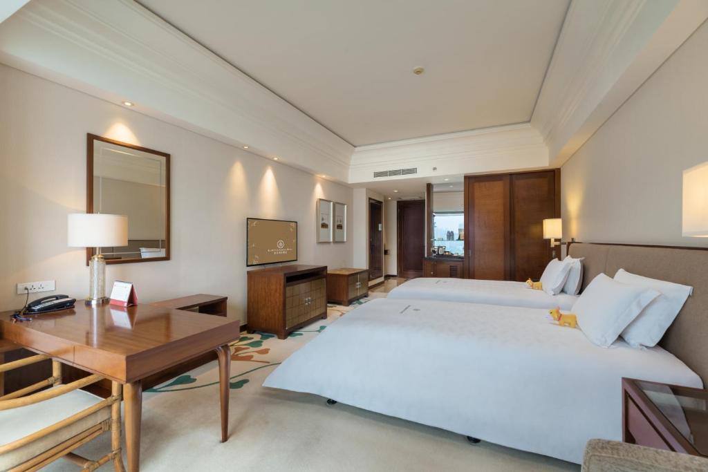 Postel nebo postele na pokoji v ubytování Huizhou Kande International Hotel