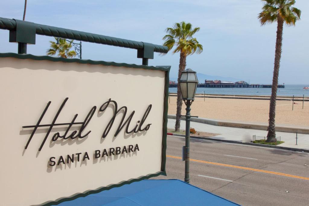a sign for a hotel in front of the beach at The Milo in Santa Barbara