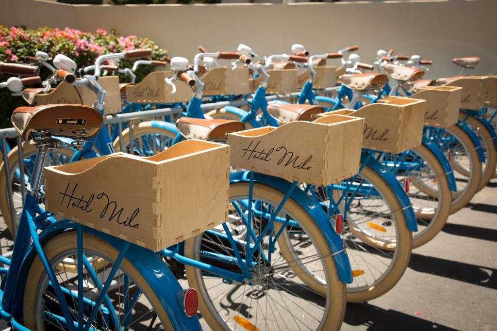 a row of blue bikes with boxes on them at The Milo in Santa Barbara