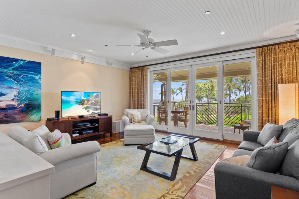 a living room with a couch and a tv at Turtle Bay Villas 307 in Kahuku