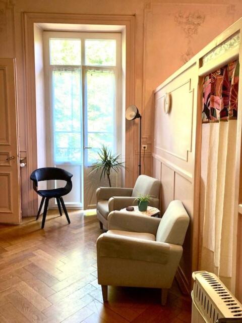 - un salon avec deux chaises et une fenêtre dans l'établissement appartement plein centre, 42m au calme avec balcon et wifi, à Aix-les-Bains