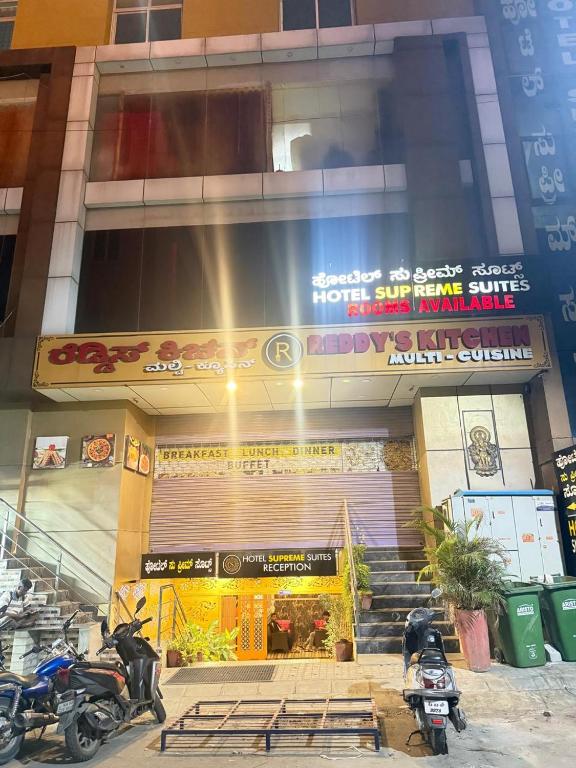 a building with motorcycles parked in front of it at SUPREME SUITs in Jāmb