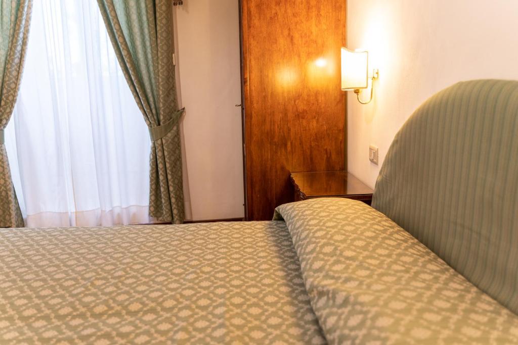Postel nebo postele na pokoji v ubytování Hotel Belvedere