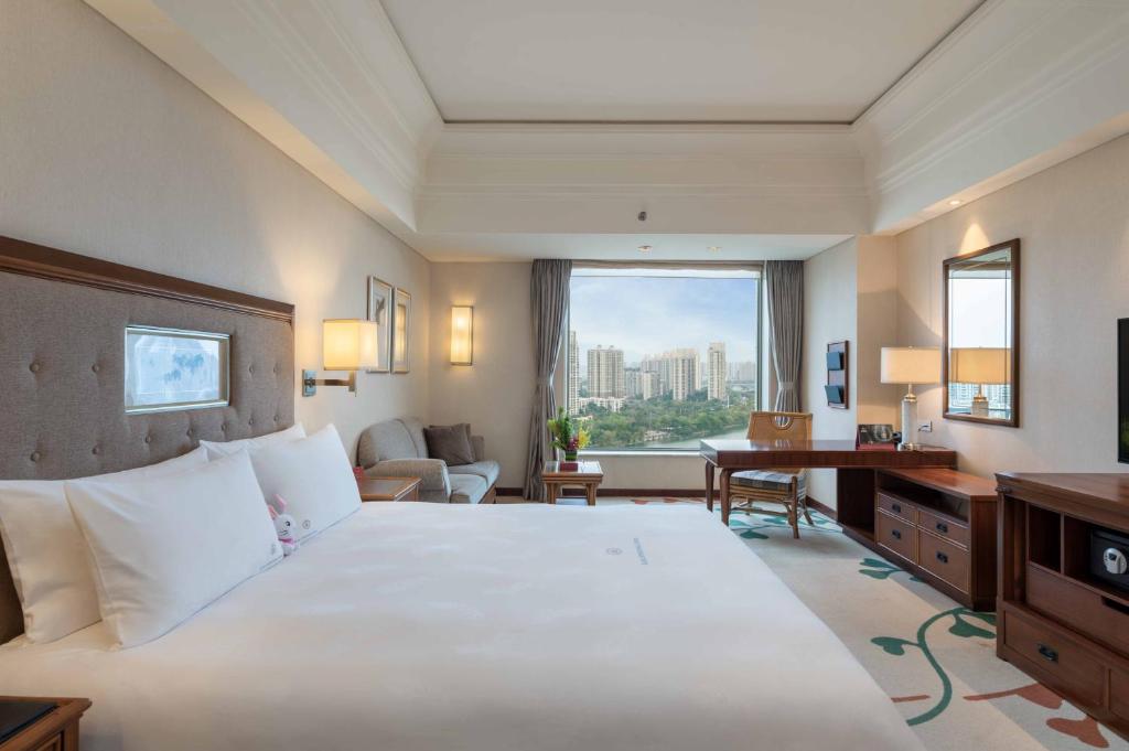 Postel nebo postele na pokoji v ubytování Huizhou Kande International Hotel