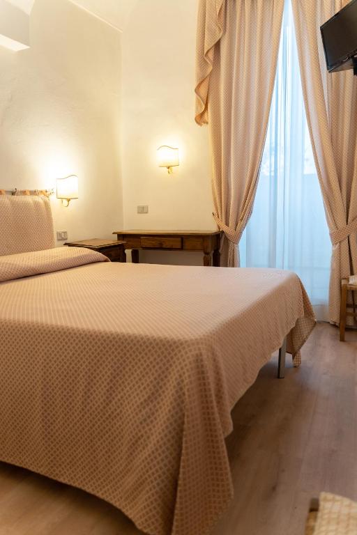 Postel nebo postele na pokoji v ubytování Hotel Belvedere