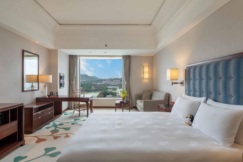 Postel nebo postele na pokoji v ubytování Huizhou Kande International Hotel