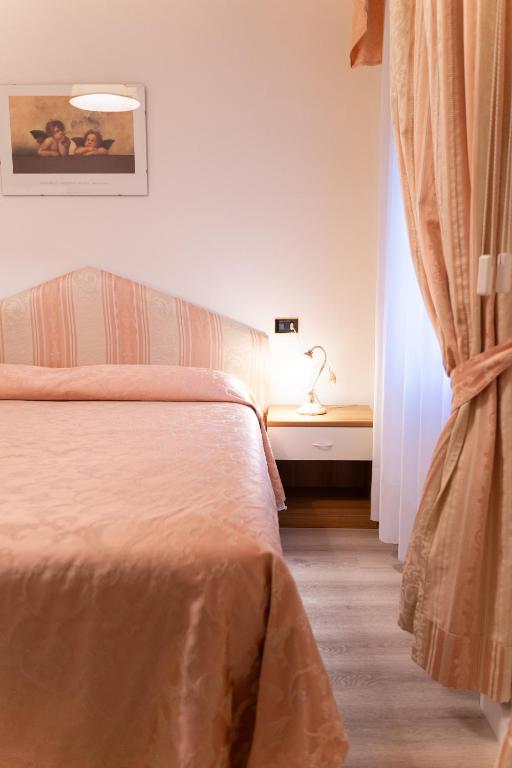 Postel nebo postele na pokoji v ubytování Hotel Belvedere
