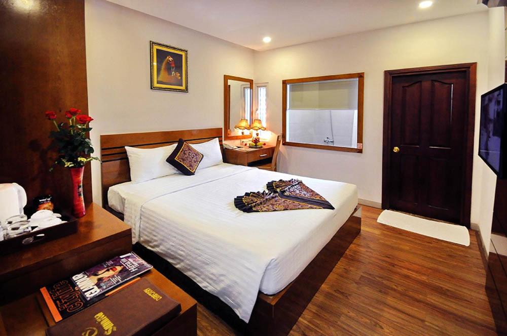 Postel nebo postele na pokoji v ubytování Sunniva Hotel Nha Trang