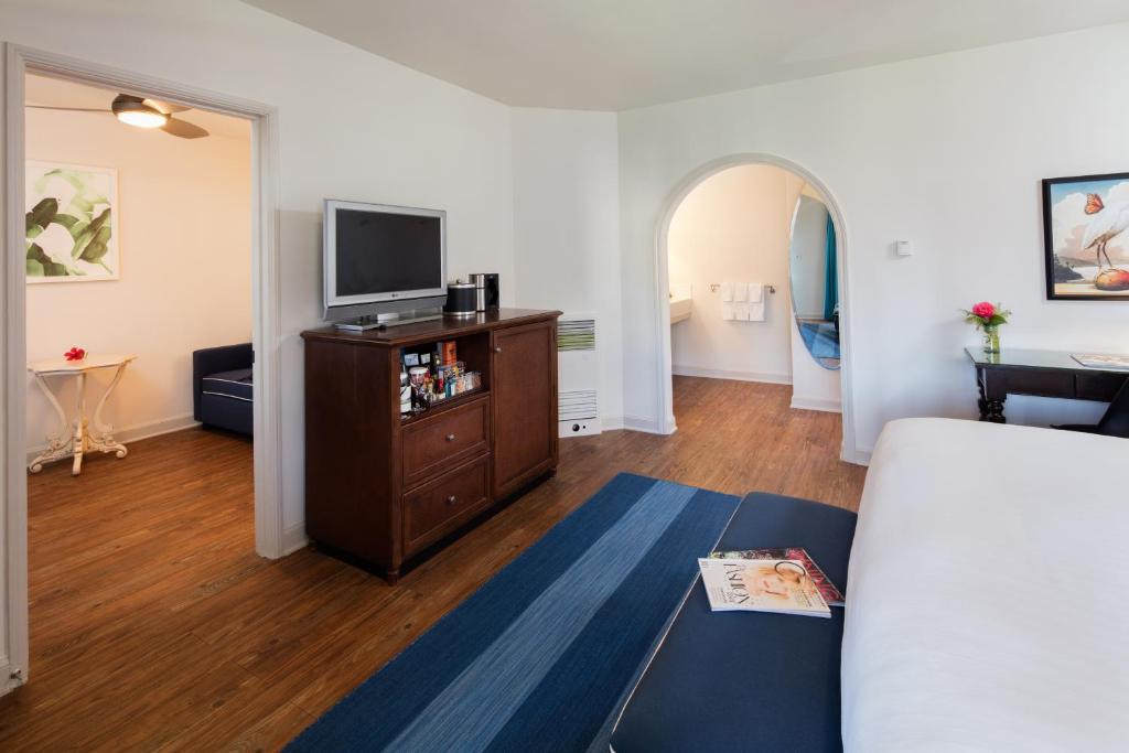 a living room with a bed and a tv at The Milo in Santa Barbara