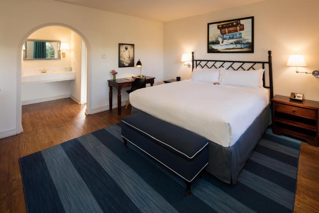 a bedroom with a large bed and a bathroom at The Milo in Santa Barbara