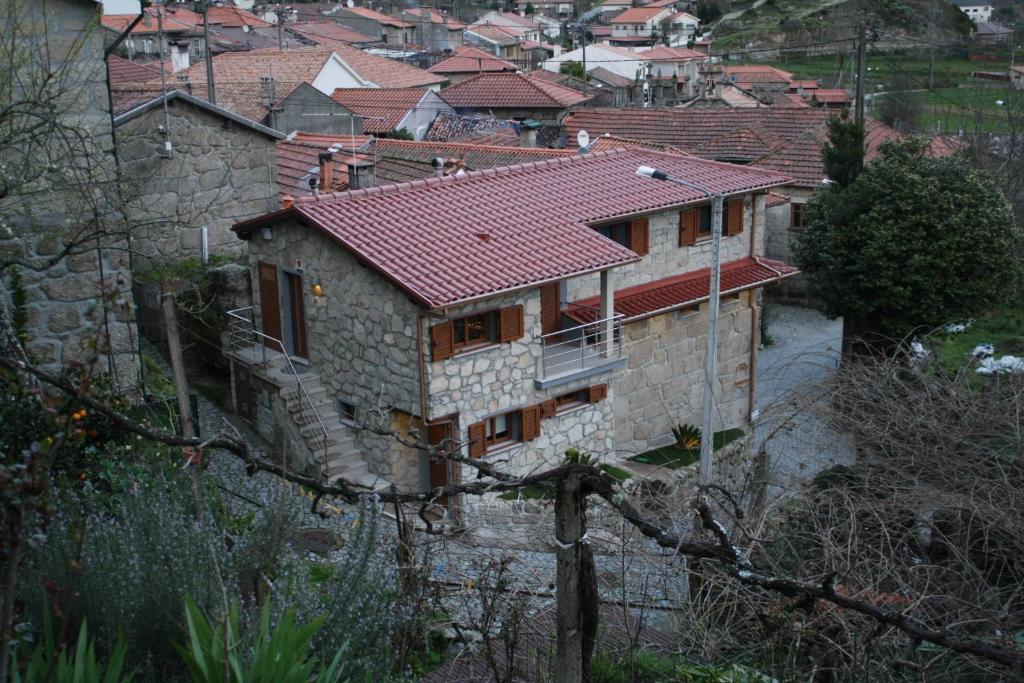 a house with a red roof in a village at Casa da Fonte Gerês in Campo do Gerês