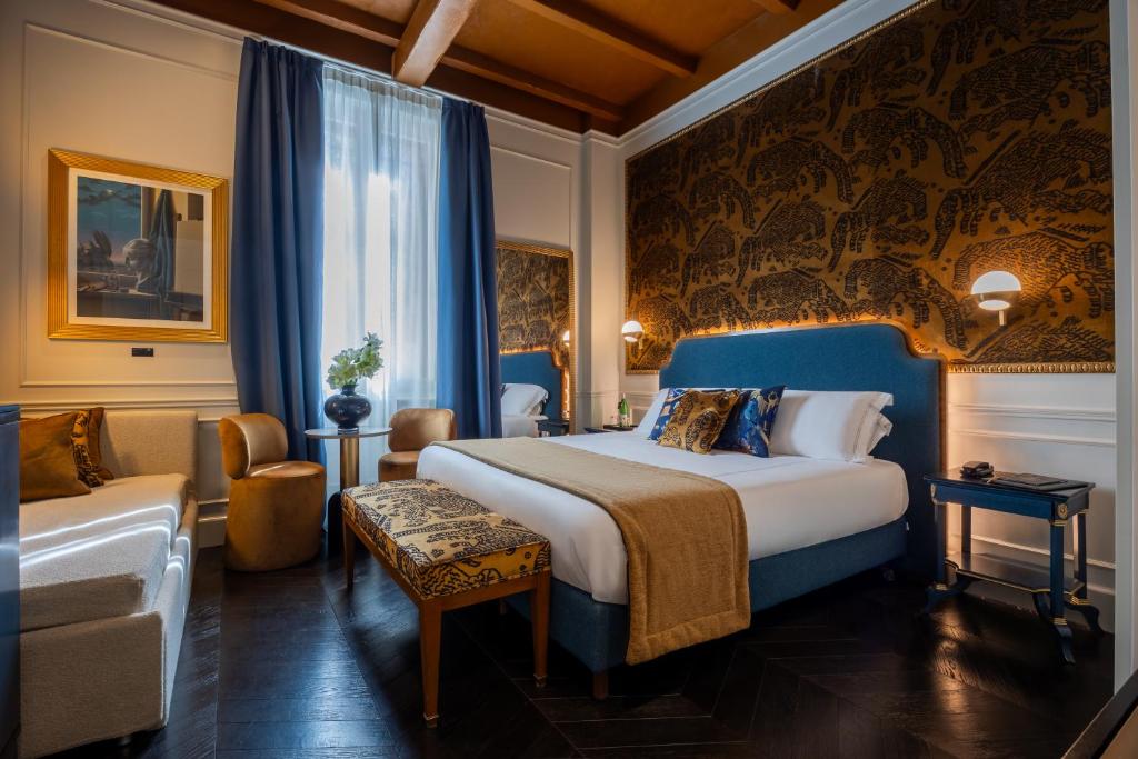 a hotel room with a bed and a chair at HT6 Hotel Roma in Rome