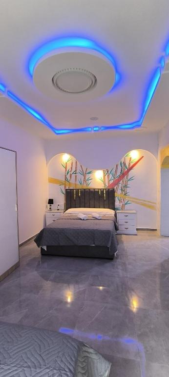 a bedroom with a bed with a blue ceiling at Casa Salma in Seville