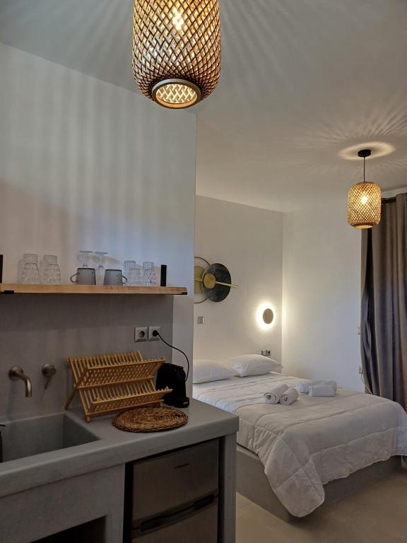 a bathroom with two beds and a sink in a room at Ραχάτι in Áyios Stéfanos