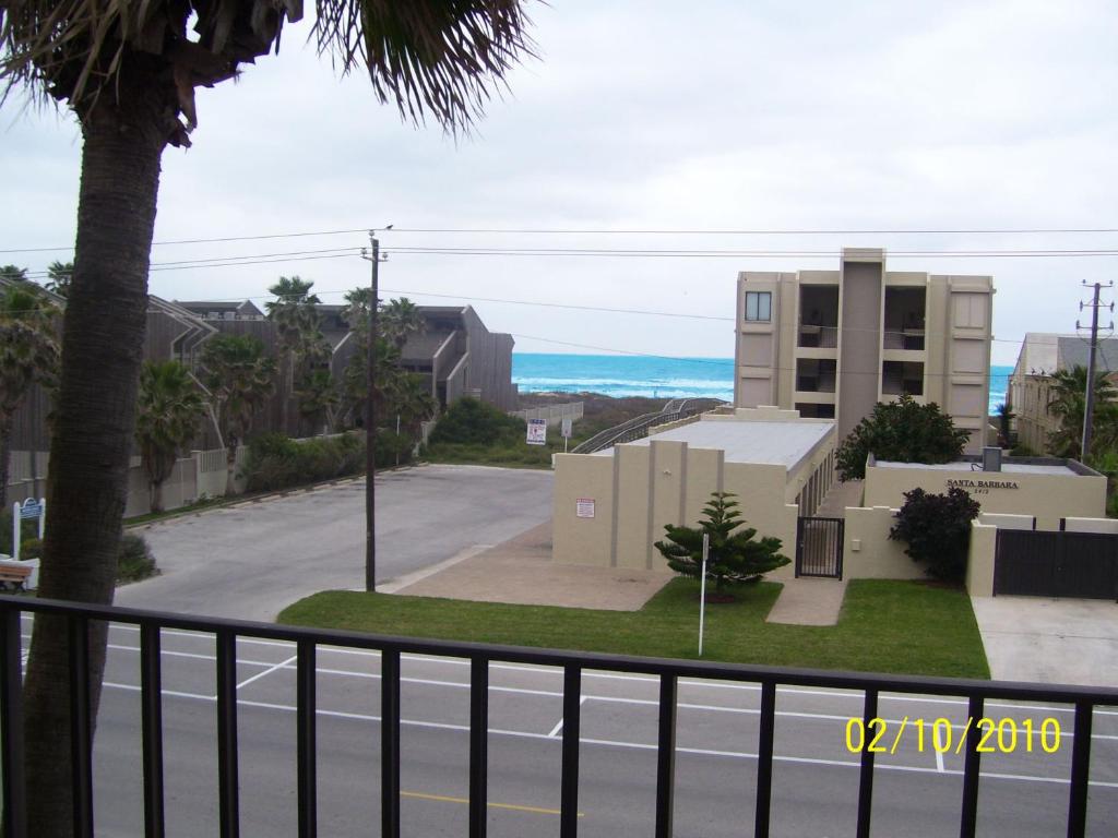 a view of a street with a building and the ocean at Beachview in South Padre Island