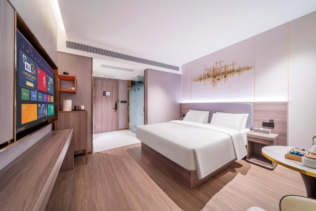 Postel nebo postele na pokoji v ubytování ChongQing Could Hotel 重庆云禧酒店