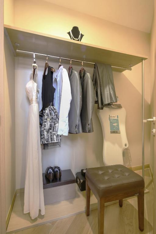 a walk in closet with a wedding dress and clothes at Green Court Residence Jinqiao Diamond Shanghai in Shanghai
