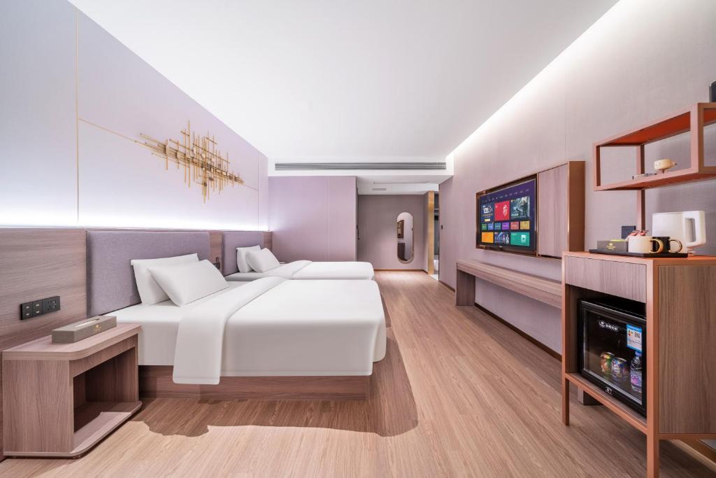 Postel nebo postele na pokoji v ubytování ChongQing Could Hotel 重庆云禧酒店