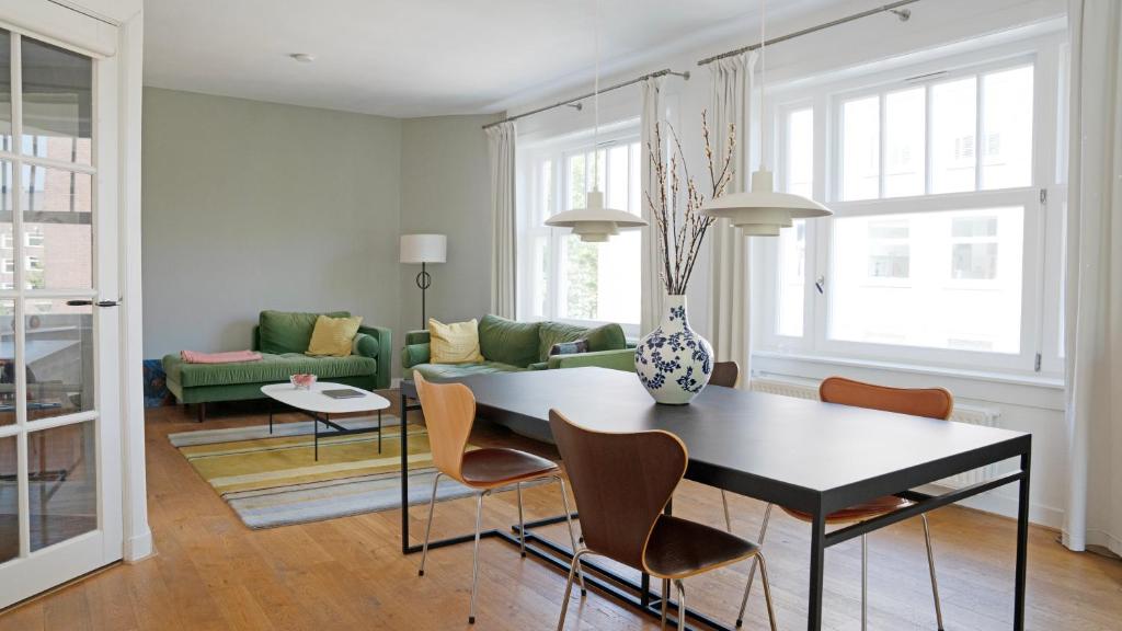 a living room with a table and a couch at Authentic Amsterdam Apartment RAI in Amsterdam