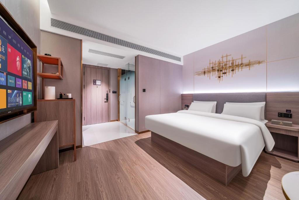 Postel nebo postele na pokoji v ubytování ChongQing Could Hotel 重庆云禧酒店