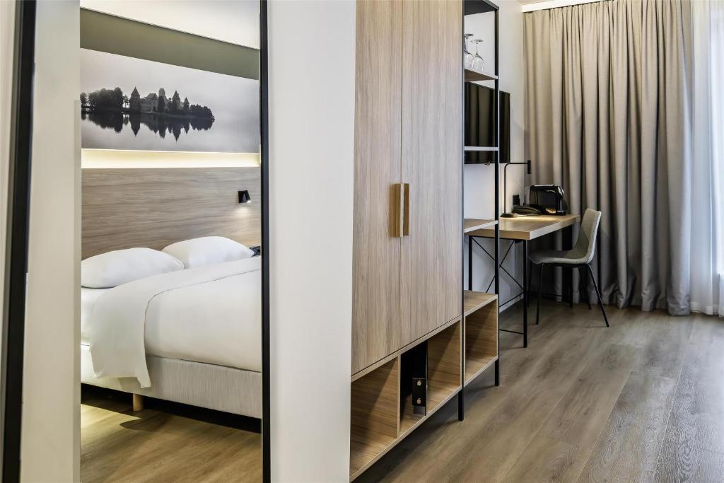 a hotel room with a bed and a desk at Park Inn by Radisson Vilnius Airport Hotel & Conference Centre in Vilnius