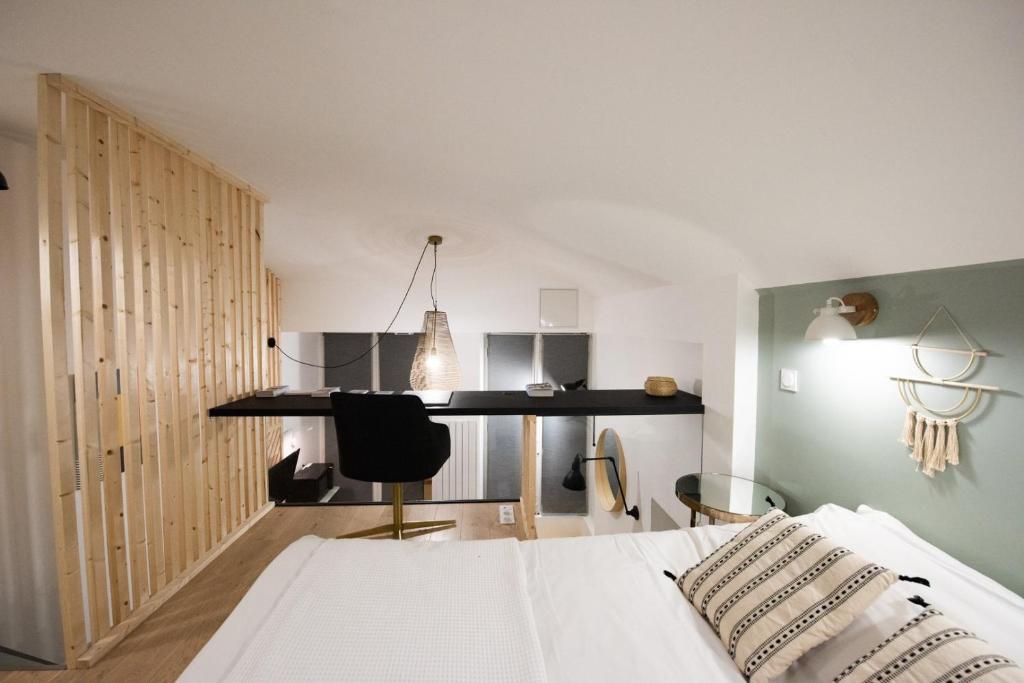 une chambre avec un lit et un bureau dans l'établissement Le duplex d'André - Un écrin cosy et design pour 2, à Lyon