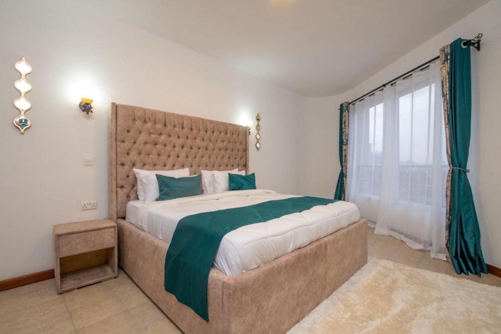 a bedroom with a large bed and a window at Exquisite 6 bedroom Villa in Nakuru in Nakuru