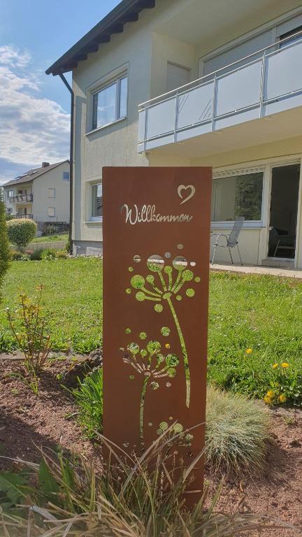 a sign in a yard in front of a house at Ferienwohnung Am Lollbach in Bad Kissingen