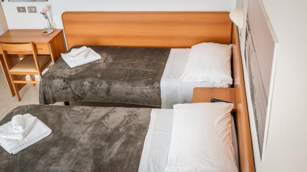 Postel nebo postele na pokoji v ubytování Hotel Fattori