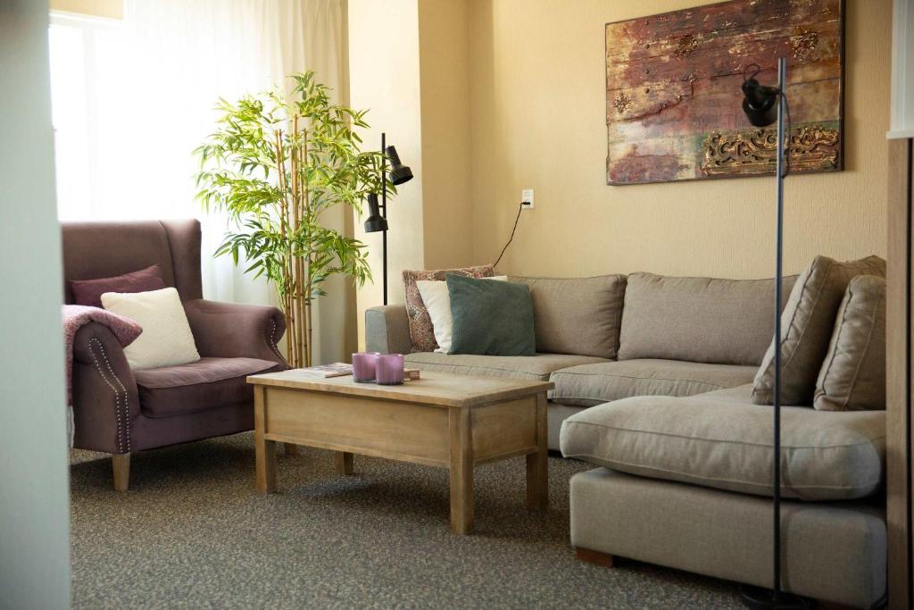 a living room with a couch and a coffee table at Hello Zeeland - Appartement Weststraat 14 in Domburg