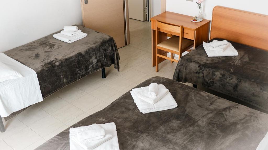 Postel nebo postele na pokoji v ubytování Hotel Fattori
