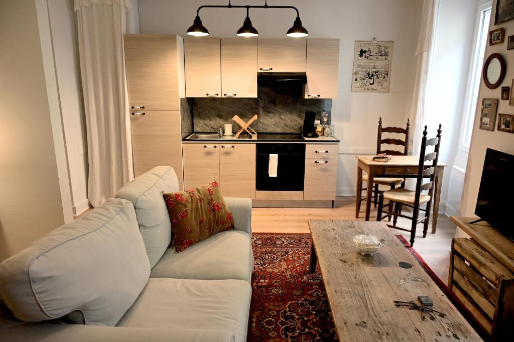 a living room with a white couch and a table at La Brocante - Meilleurhote-Brioude in Brioude