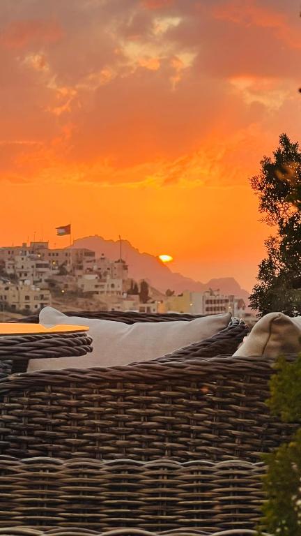 a view of a city with the sunset in the background at Tetra Tree Hotel 1 in Wadi Musa
