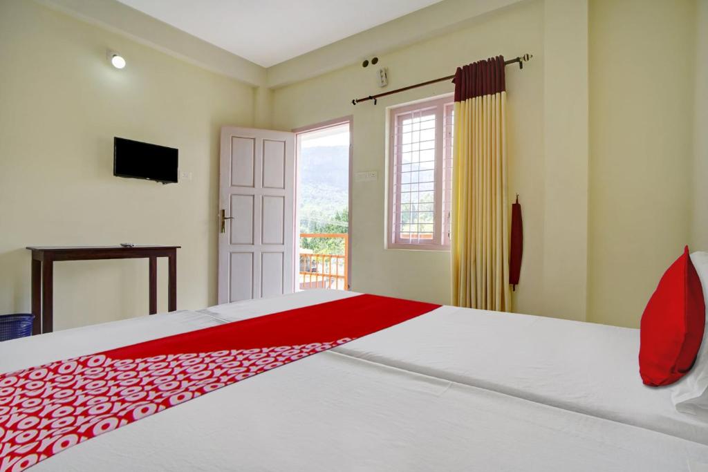 Postel nebo postele na pokoji v ubytování Hotel O Lulu Home