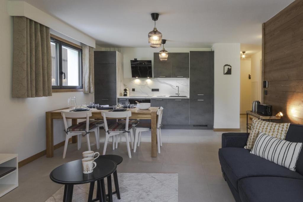 Il comprend un salon et une cuisine avec une table et des chaises. dans l'établissement Le mazot de Kayla - Mazot de Kayla - Vue Mont-Blan, aux Houches