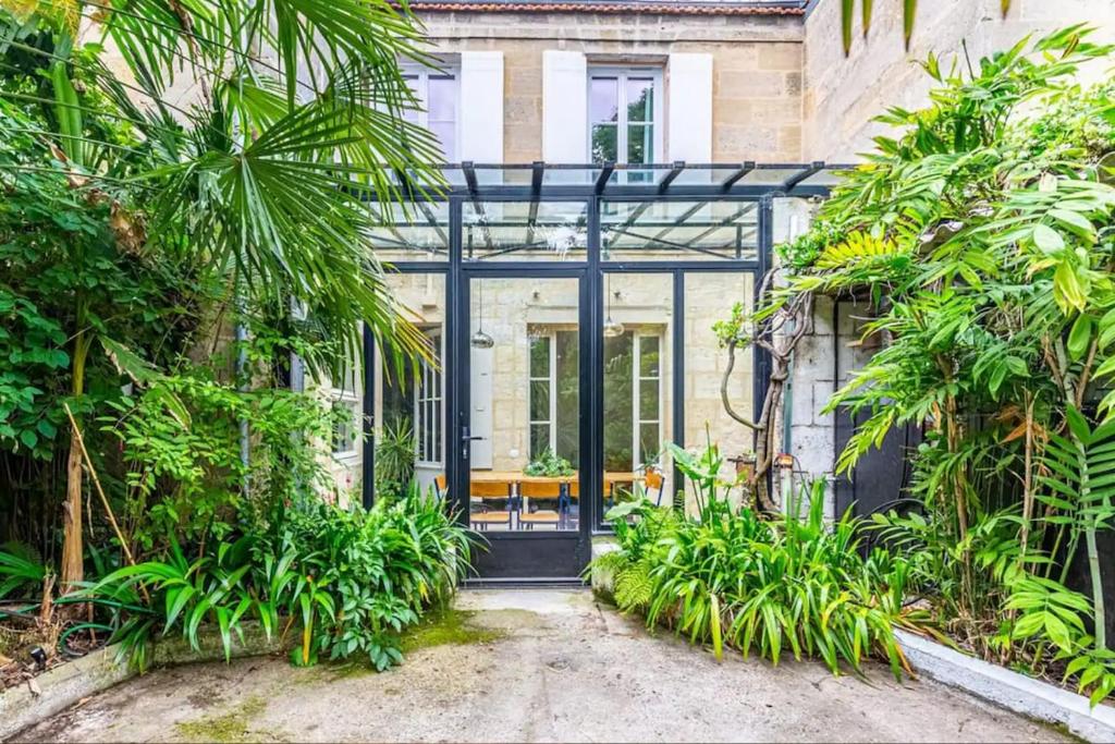 a house with a black door and some plants at Tropical House in Bordeaux