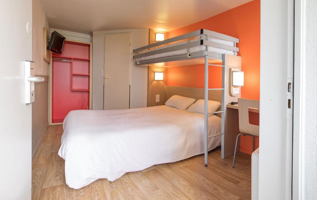 a bedroom with a bunk bed and a desk at Premiere Classe Nantes Est St Sebastien Sur Loire in Saint-Sébastien-sur-Loire