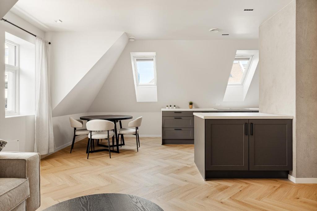 a kitchen and dining room with a table and chairs at Bergen City Living in Bergen