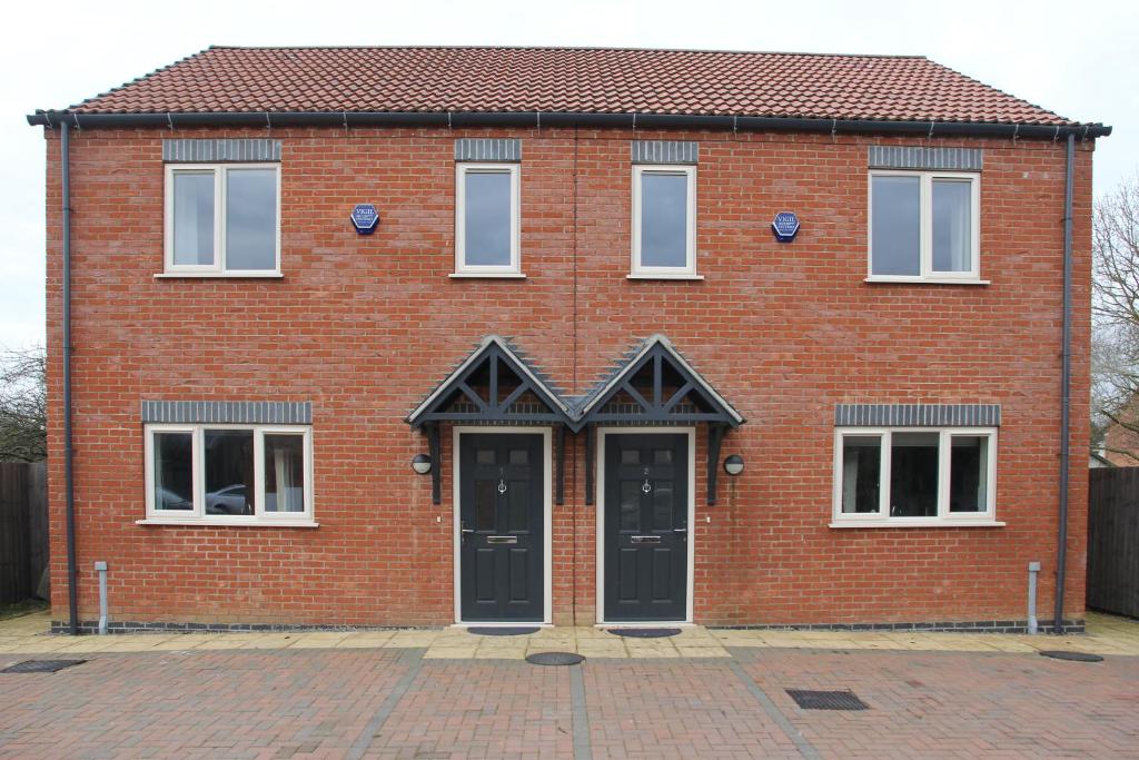 a red brick house with two black doors at Newark area - modern 3 bedroom semi with free off road parking for 2 vehicles in Balderton
