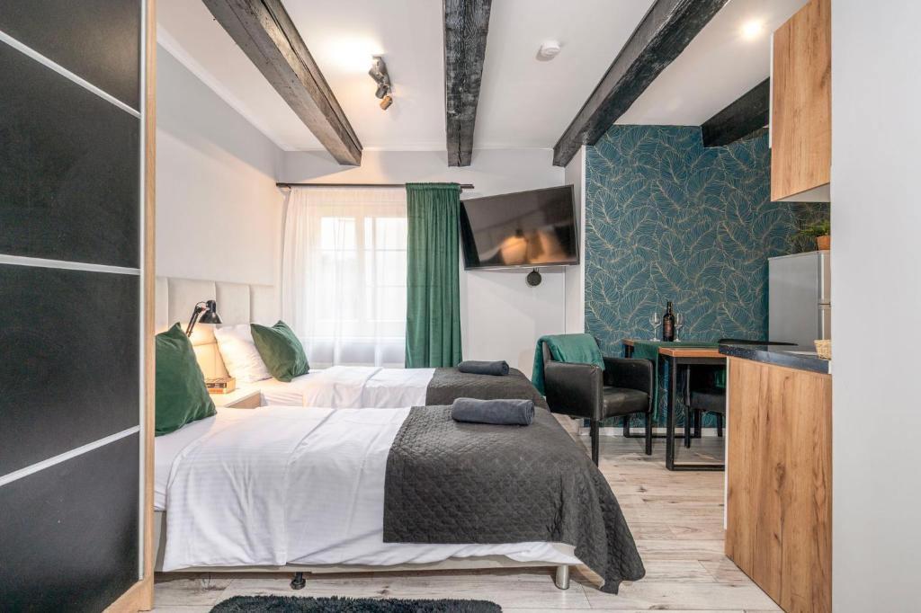 Posteľ alebo postele v izbe v ubytovaní Kościelna Loft Apartaments
