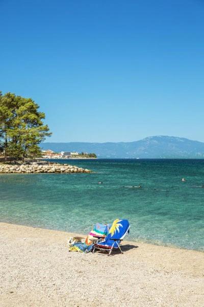a beach chair sitting on the sand on the beach at Dubasa B&B in Vantačići