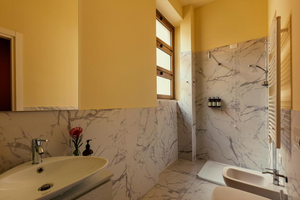 a bathroom with a sink and a mirror at Bob W Ticinese in Milan