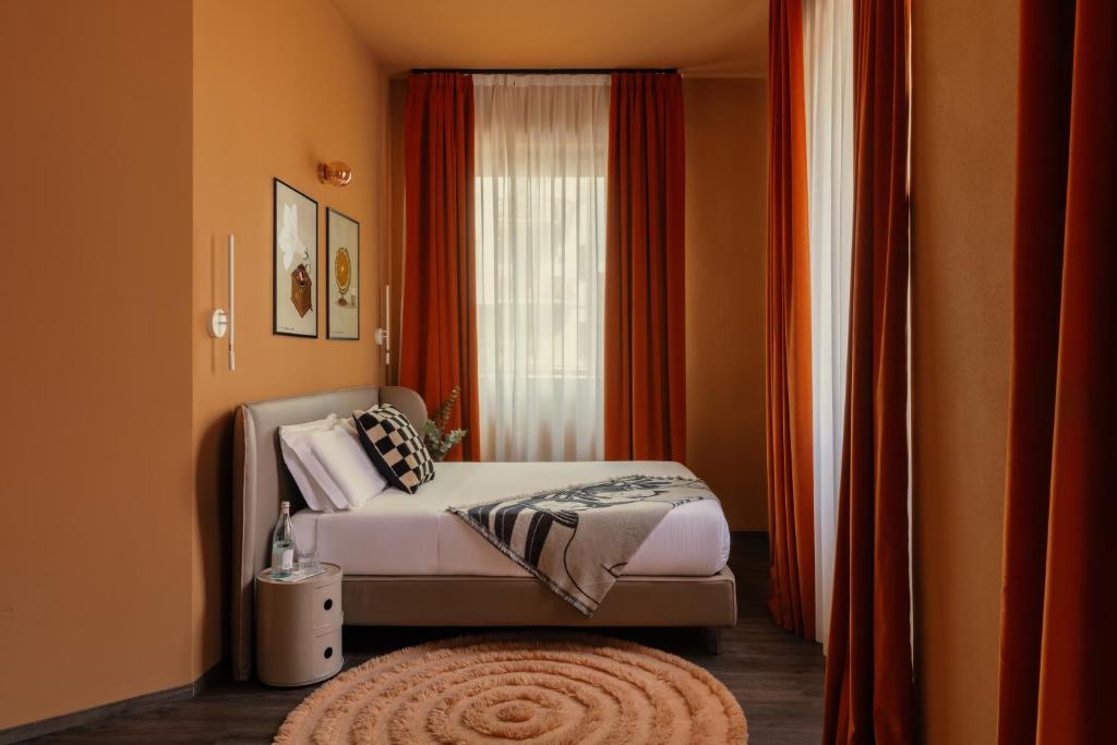 a bedroom with a bed and a window and a rug at Bob W Ticinese in Milan