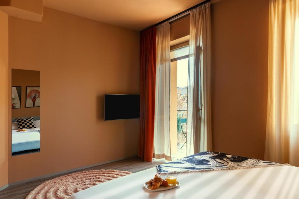 a bedroom with a bed and a window at Bob W Ticinese in Milan
