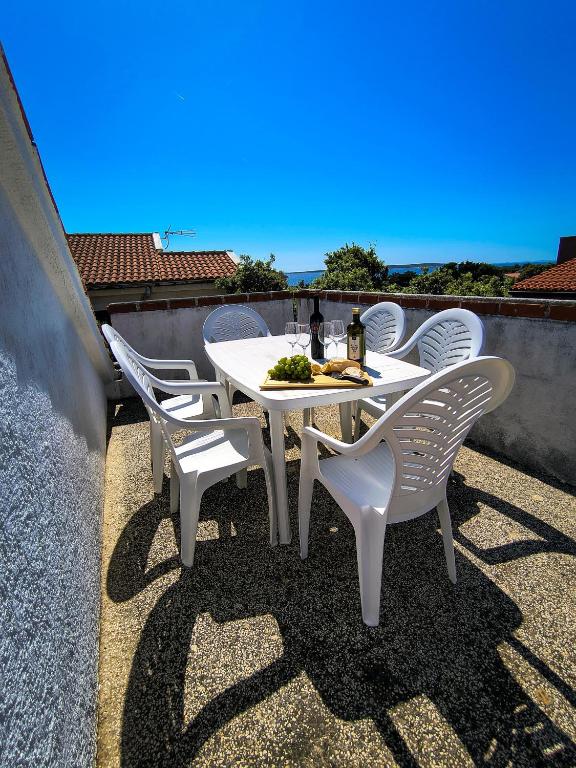 a white table and chairs sitting on a roof at Villa Terraca in Mandre