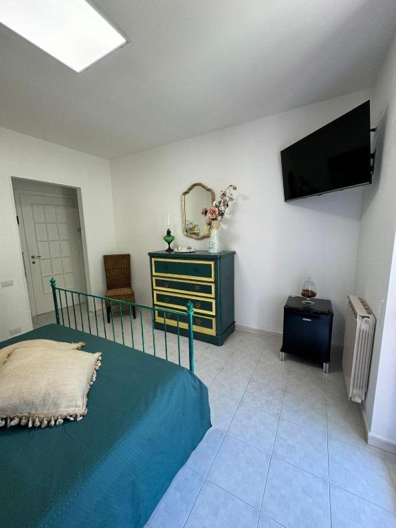 a bedroom with a bed and a tv on the wall at Jungle Rooms in Cetara