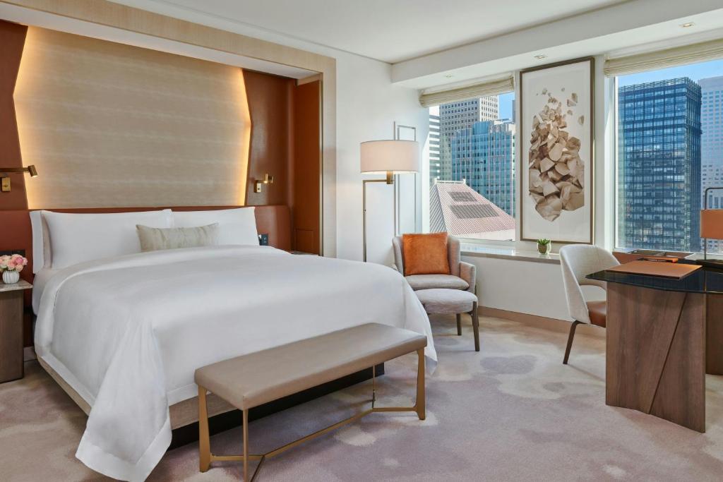 a bedroom with a large white bed and a desk at The St. Regis San Francisco in San Francisco