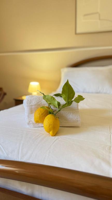 a bed with towels and lemons on it at Casa del Salento Il Limone in Trepuzzi